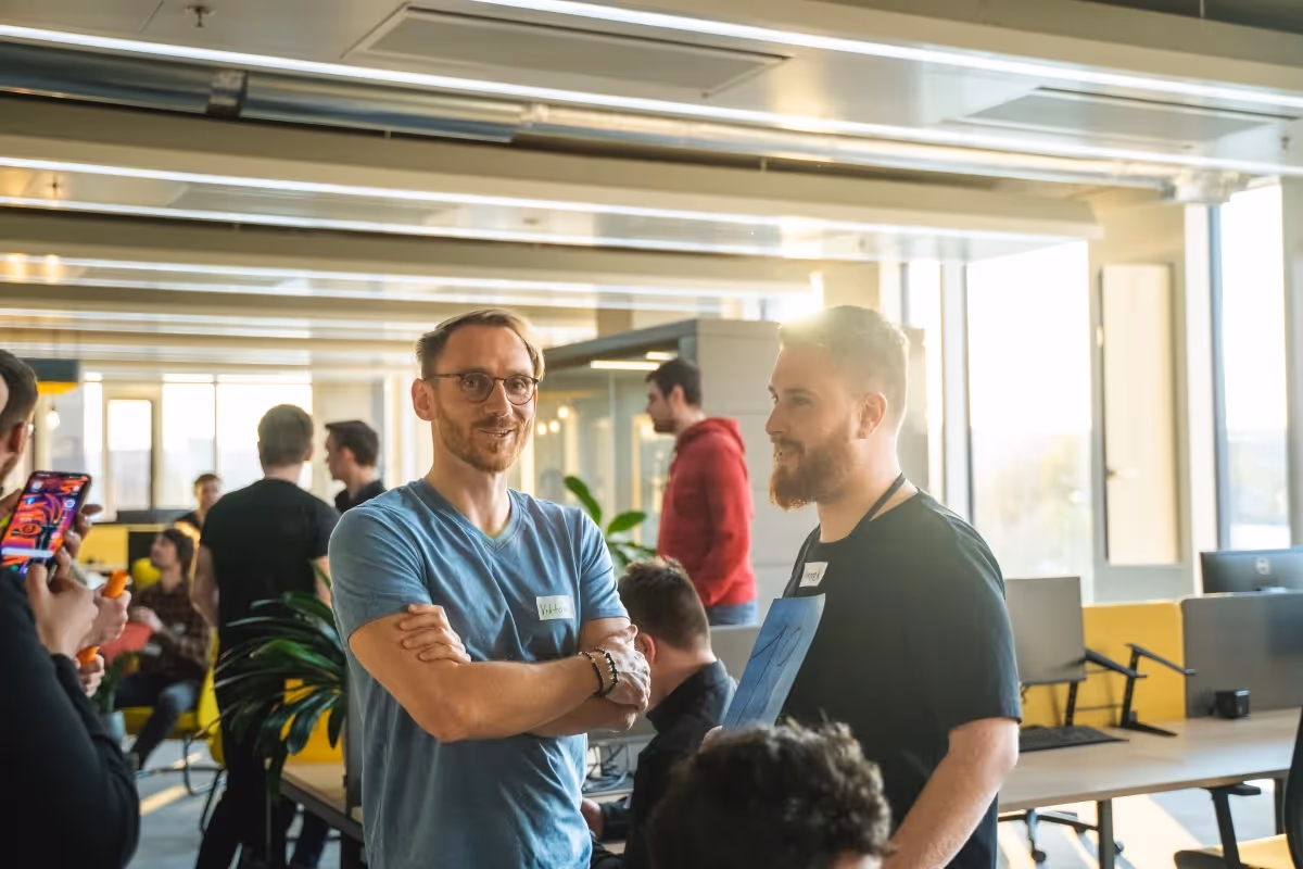 Developers talking in sunny Cleevio office before hackaton start