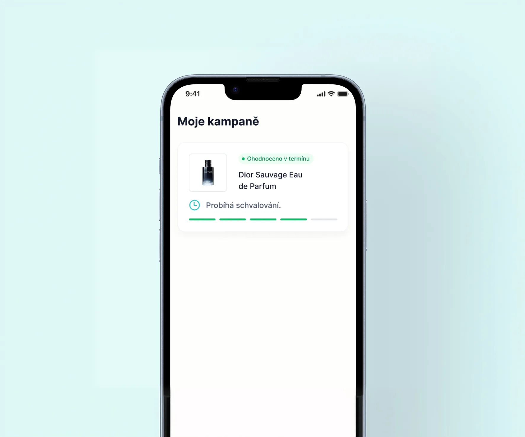 A phone on pale teal with the Moje kampaně screen: the Dior Sauvage Eau de Parfum campaign marked Ohodnoceno v termínu and its approval in progress